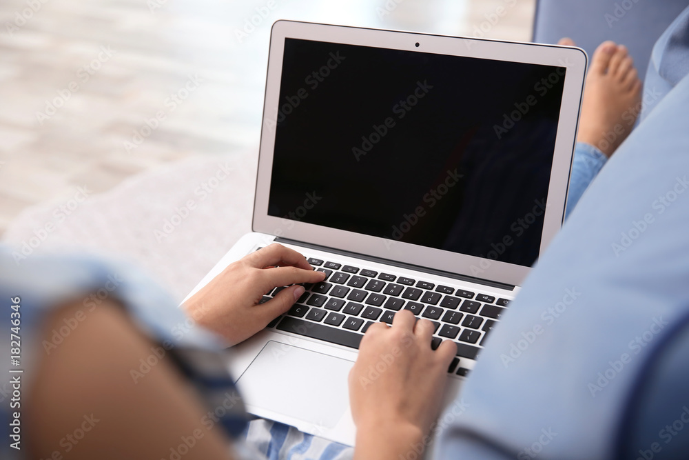 Woman using laptop at home Woman using laptop at home