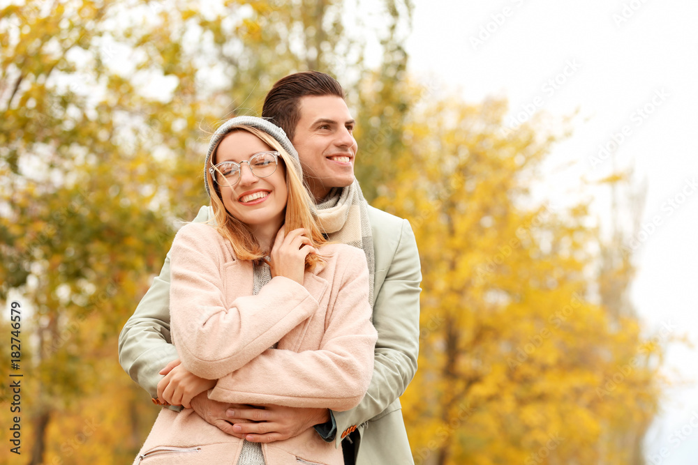Fototapeta premium Young couple in park on autumn day
