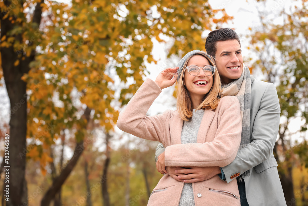 Young couple in park on autumn day Young couple in park on autumn day