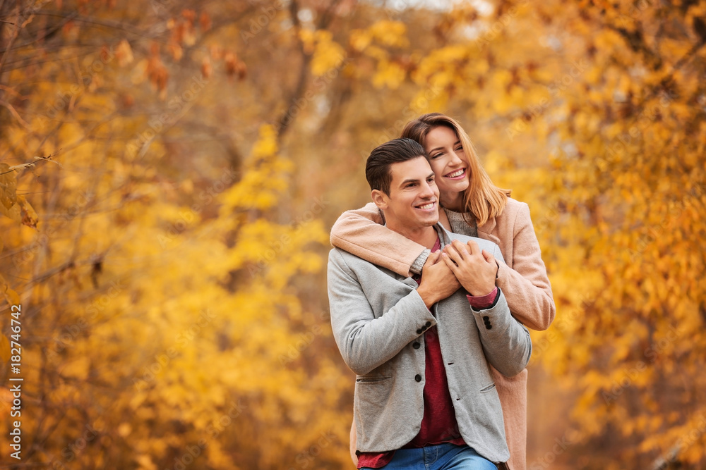 Young couple in park on autumn day Young couple in park on autumn day