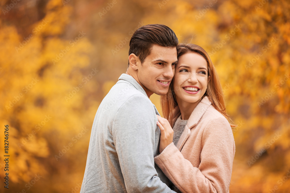 Young couple in park on autumn day Young couple in park on autumn day