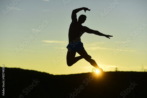 Sport and training concept. Silhouette of athlete jumping elegantly