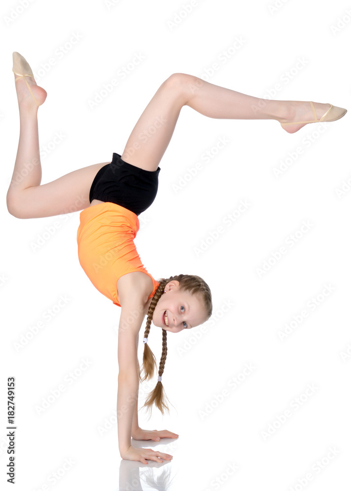 The gymnast performs a handstand with bent legs. The gymnast performs a handstand with bent legs.