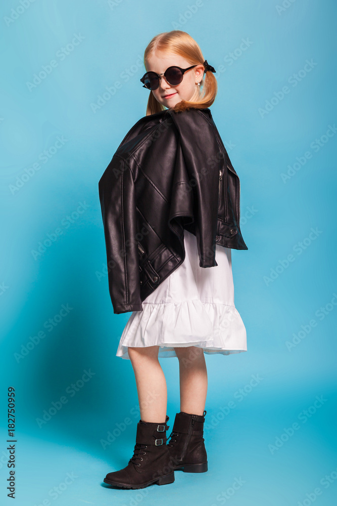 little girl with tails in stylish clothes on blue background little girl with tails in stylish clothes on blue background