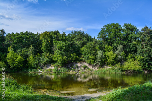 Summer day on the river  landscape  blue sky with clouds.