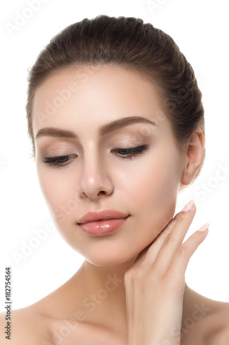 Portrait of young beautiful caucasian woman touching her face