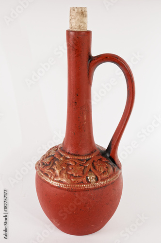 Clay pitcher for wine on white background.