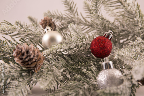 Christmas branch with red and silver ornaments