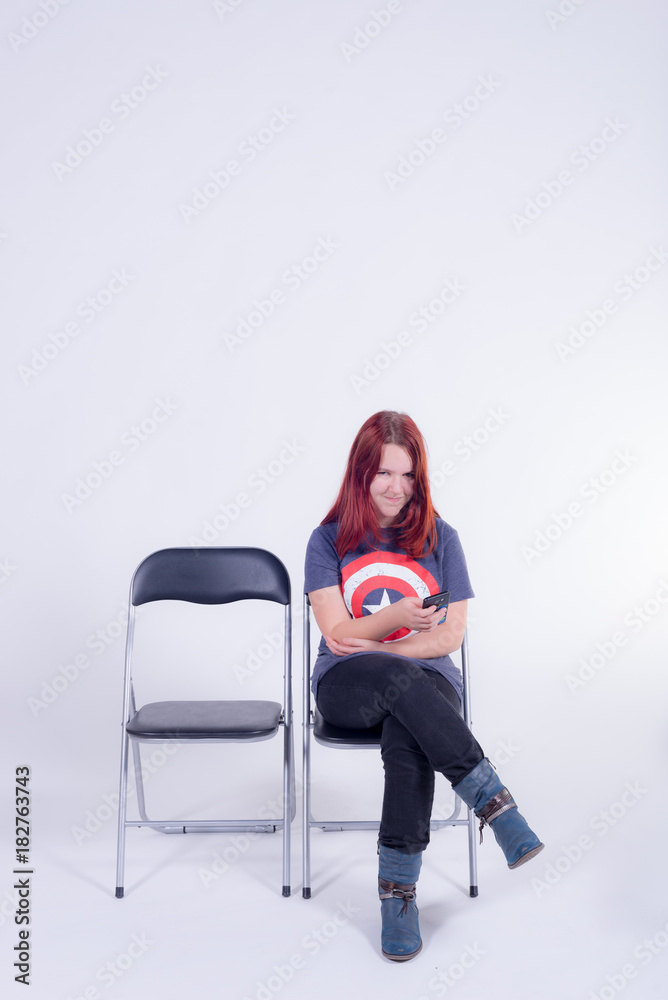 Girl looking mischievous while fondling her smartphone Girl looking mischievous while fondling her smartphone