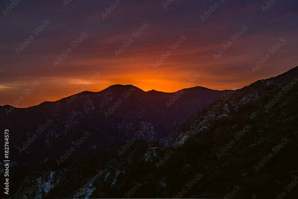 Sunsetting Behind California Mountain