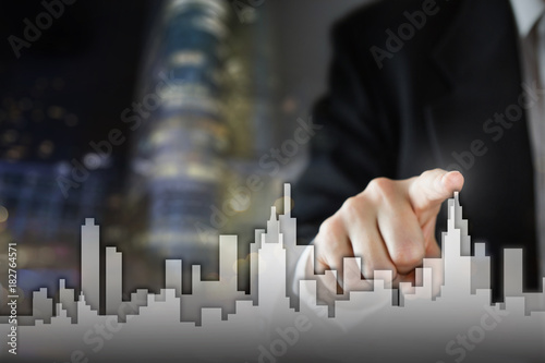 Businessman Activate Growth Process, choosing house, real estate city concept. Skyline Hand pressing the house icon on virtual screen. Business, technology, internet and networking concept. Copy space photo