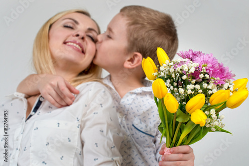 Son gives his beloved mother a beautiful bouquet of tulips.The concept of the celebration,women's day.
