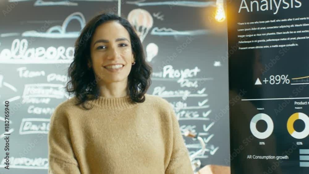 Female Project Manager Smiles and Shows Statistical Graphs and Charts on the Interactive White Board. Shot on RED EPIC-W 8K Helium Cinema Camera. Female Project Manager Smiles and Shows Statistical Graphs and Charts on the Interactive White Board. Shot on RED EPIC-W 8K Helium Cinema Camera.