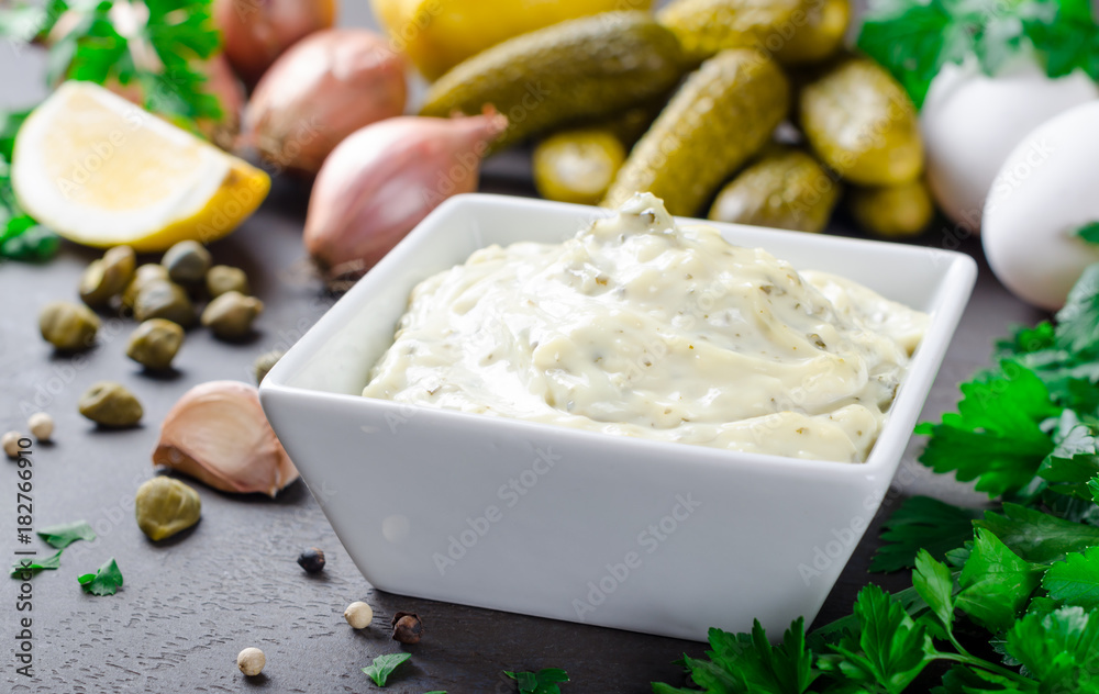 Traditional french sauce remoulade in a white bowl with ingredie