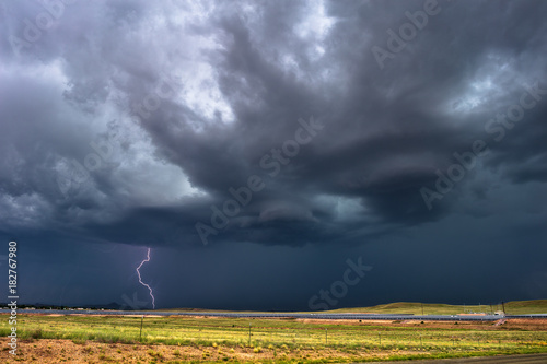 Photography Ominous dark clouds and lightning in a dramatic summer thunderstorm
