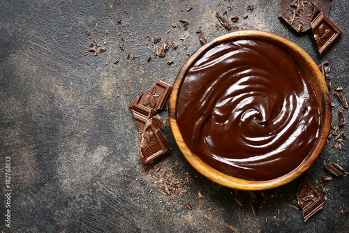 Chocolate ganache in a wooden bowl .Top view with copy space.