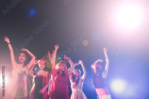 new year party, holidays, celebration, nightlife and people concept - Young people having fun dancing at a party.