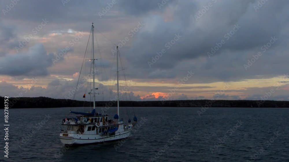 Sailboat in Great Darwin Bay at sunrise, Genovesa Island, Galapagos National Park, Ecuador Sailboat in Great Darwin Bay at sunrise, Genovesa Island, Galapagos National Park, Ecuador