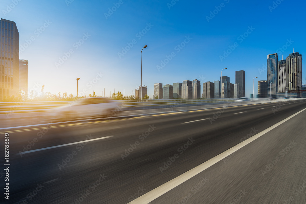 Empty urban road and modern skyline