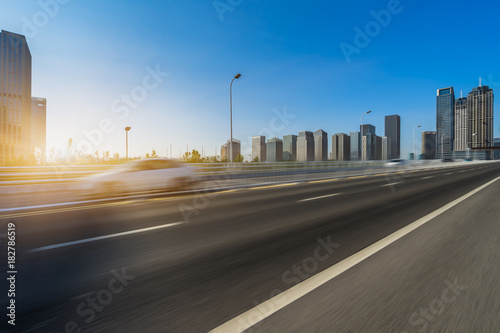 Empty urban road and modern skyline