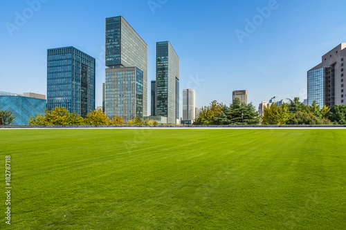 modern cityscape and skyline from meadow in park
