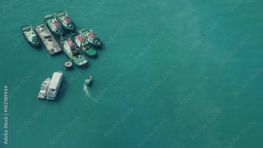 Hong Kong - October 2017: Elevated view of industrial port. Close up of small passenger boat. 4K resolution. Hong Kong - October 2017: Elevated view of industrial port. Close up of small passenger boat. 4K resolution.