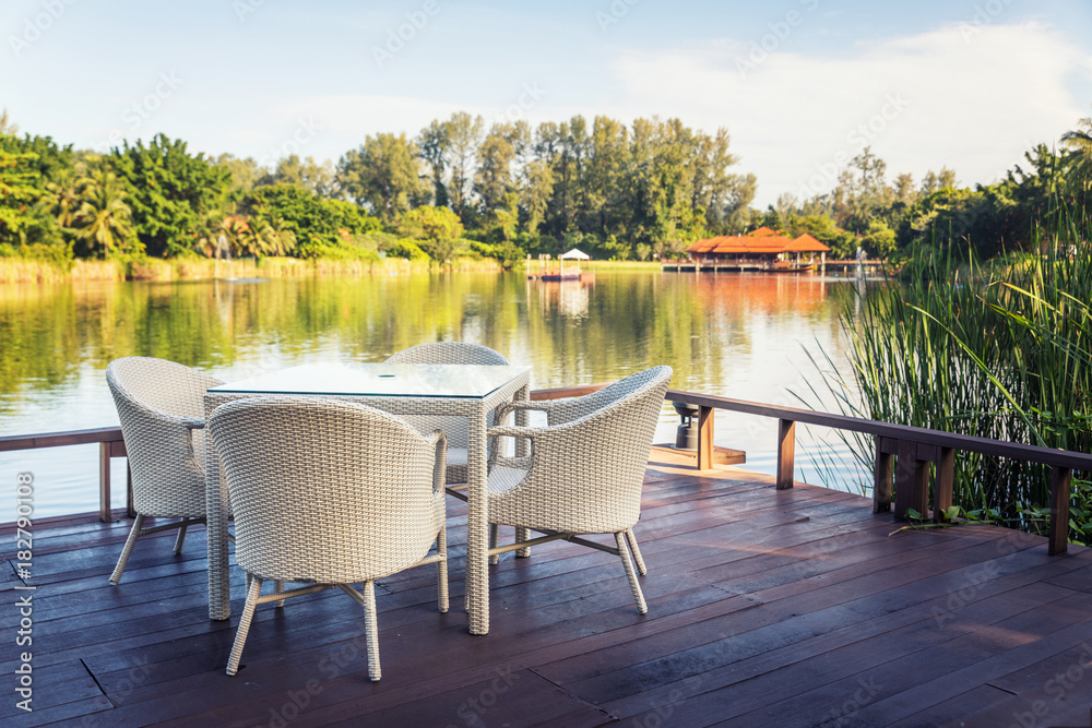 Outdoor white garden dining table by water side