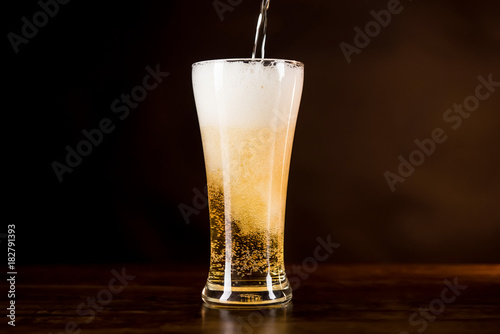 Wallpaper Mural Cold beer being poured into the glass with frothy foam on top Torontodigital.ca