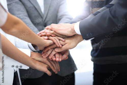 business colleagues with their hands stacked together