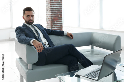 businessman sitting in the lobby of a modern office. © ASDF