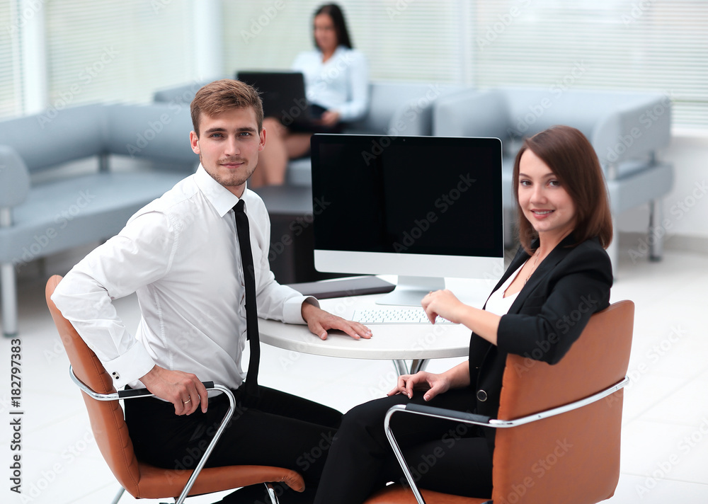 smiling member of the business team sitting at Desk smiling member of the business team sitting at Desk