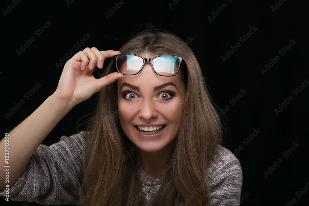 Portrait of beautiful girl over black background with glasses Portrait of beautiful girl over black background with glasses