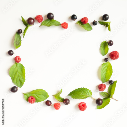 Composition with Fresh mint leaves and red raspberries and black