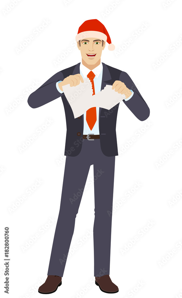 Businessman in Santa hat tearing a piece of paper Businessman in Santa hat tearing a piece of paper