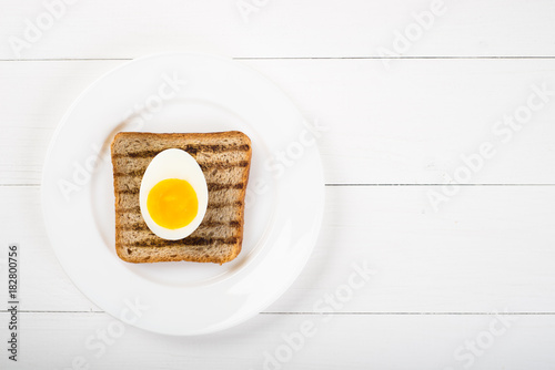 Top view of Healthy Sandwich toast and half of egg on a wooden background