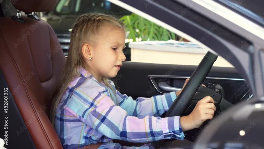 A nice girl is trying to start a car A nice girl is trying to start a car