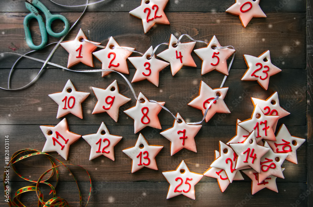 Gingerbread star cookies garland. Christmas concept. Wooden background. Toned.