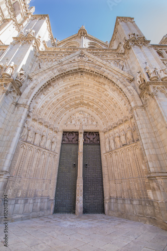 sculptures and ancient art reliefs on exterior facade of main door of the Primate Cathedral of Saint Mary, landmark and monument of the thirteenth century in Toledo city, Spain, Europe. Vertical
