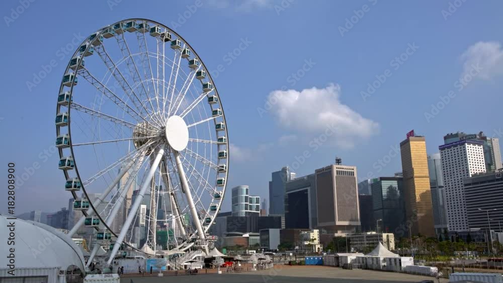 4K Observation big ferris wheel and amusement rides in central Hong Kong. Downtown skyline in the background-Dan 4K Observation big ferris wheel and amusement rides in central Hong Kong. Downtown skyline in the background-Dan