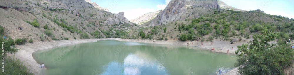The panorama of the Arpat (Crimea) natural boundary with the trolley above the volcanic lake The panorama of the Arpat (Crimea) natural boundary with the trolley above the volcanic lake