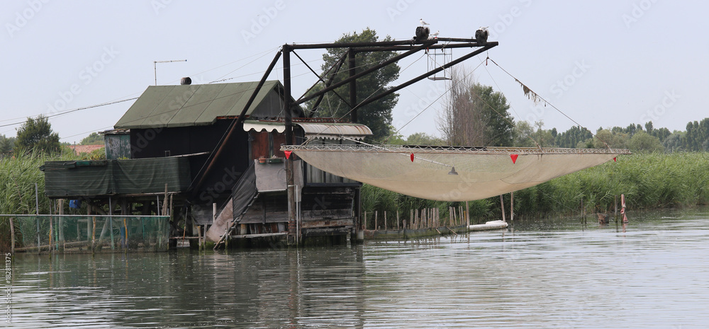 stilts houses with fishing nets for fishing on the river