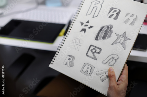Valokuva Hand Holding Notebook With Drew Brand Logo Creative Design Ideas