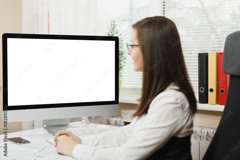 Close up portrait of beautiful business woman in suit working at computer with documents in light office, looking at the monitor. Copy space for advertisement. Close up portrait of beautiful business woman in suit working at computer with documents in light office, looking at the monitor. Copy space for advertisement.