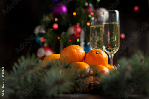 traditional New Year's table, tangerines, champagne, Christmas tree and New Year's lights