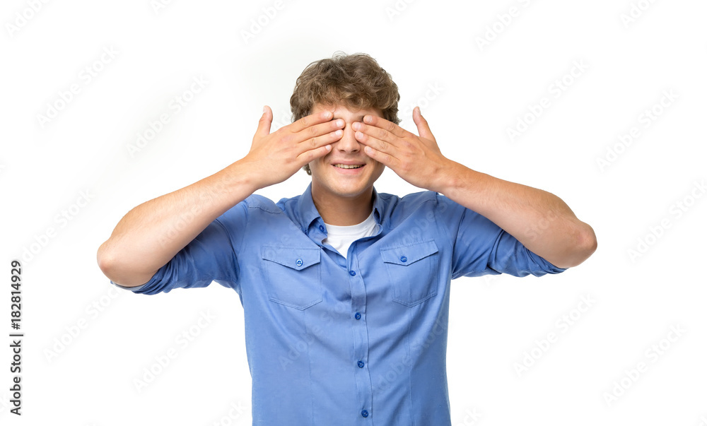 Gesture - do not see anything, close your eyes with your hands. Emotional man in blue shirt on white background. Gesture - do not see anything, close your eyes with your hands. Emotional man in blue shirt on white background.
