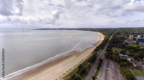 Editorial Swansea, UK - July 29, 2017: A view of Swansea West and the long stretch of sand swept Swansea Bay showing Oystermouth Road, Swansea University, Singleton Park and The Mumbles, .