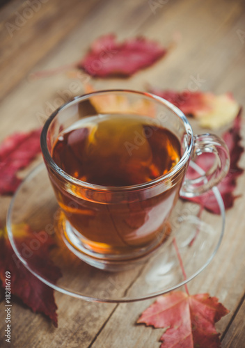 Cup of tea on the rustic background with autumn decoration. Selective focus. Shallow depth of field.
