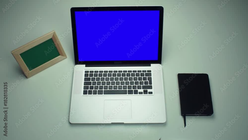 Top view male hands putting on office supplies on the desk. Top view male hands putting on office supplies on the desk.