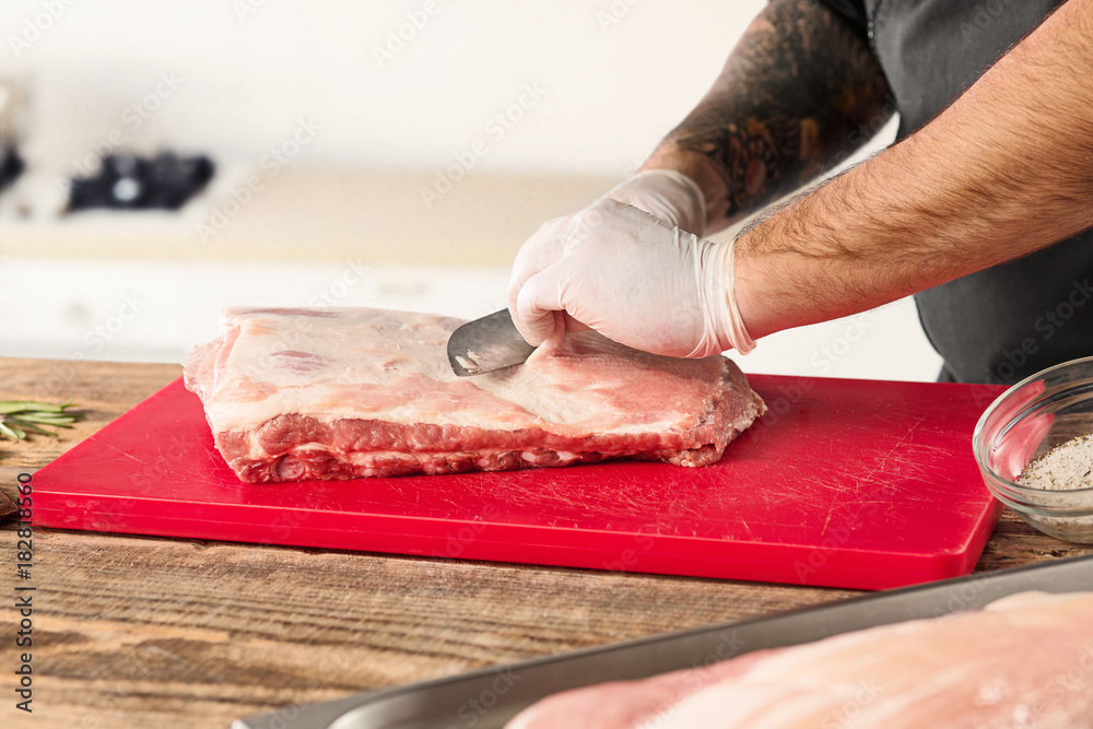Man cooking meat steak on kitchen Man cooking meat steak on kitchen