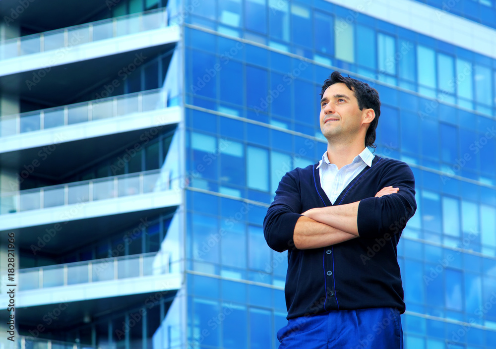 Fototapeta premium Entrepreneur. Portrait of a man of 35 years old on the background of an office building.